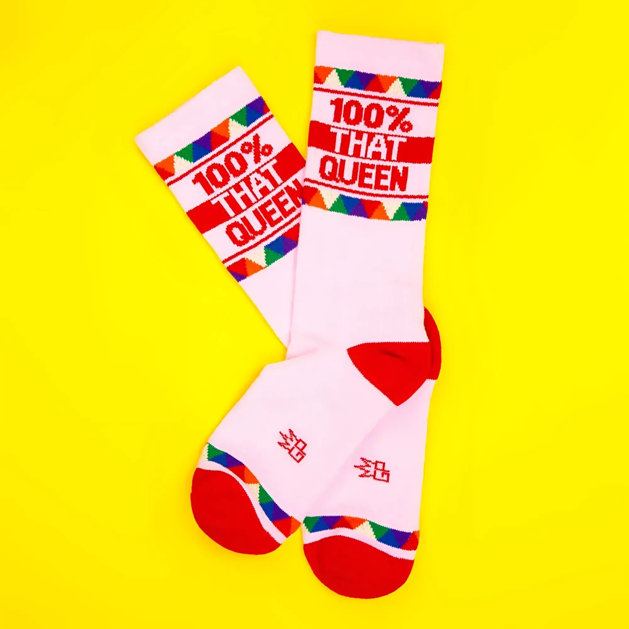 White crew socks with red accents colorful triangular patterns and bold red text 100 percent that queen