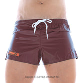 Maroon shiny metroMalewear iron sports swim trunks with white drawstring and orange logo on left leg