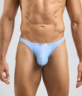 Light blue seamless fabric briefs with white brand tag at waistband from justin + simon men’s sexy peachskin tanga collection