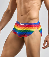 Justin + simon running short rainbow-striped men’s swim trunks with vibrant multicolored design and repeating logo