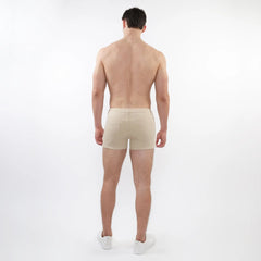 Beige 3 inch stretch knit short athletic briefs with sleek minimalist design and subtle stitching details