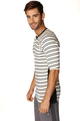 A man wearing a 4-rth mens vintage-stripe henley tee in navy double stripe french terry loop with black and white stripes