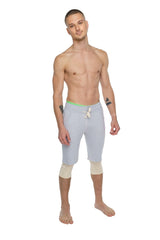 Light gray athletic shorts with neon green waistband and white drawstring designed for performance yoga and exercise