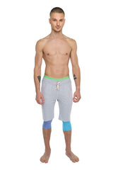 Performance yoga leggings 3/4 length coral heather with light gray athletic shorts featuring neon green waistband and blue patches
