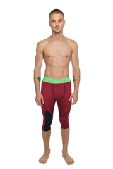 Performance yoga leggings 3/4 in brick red heather with maroon and black fabric and a bright green waistband