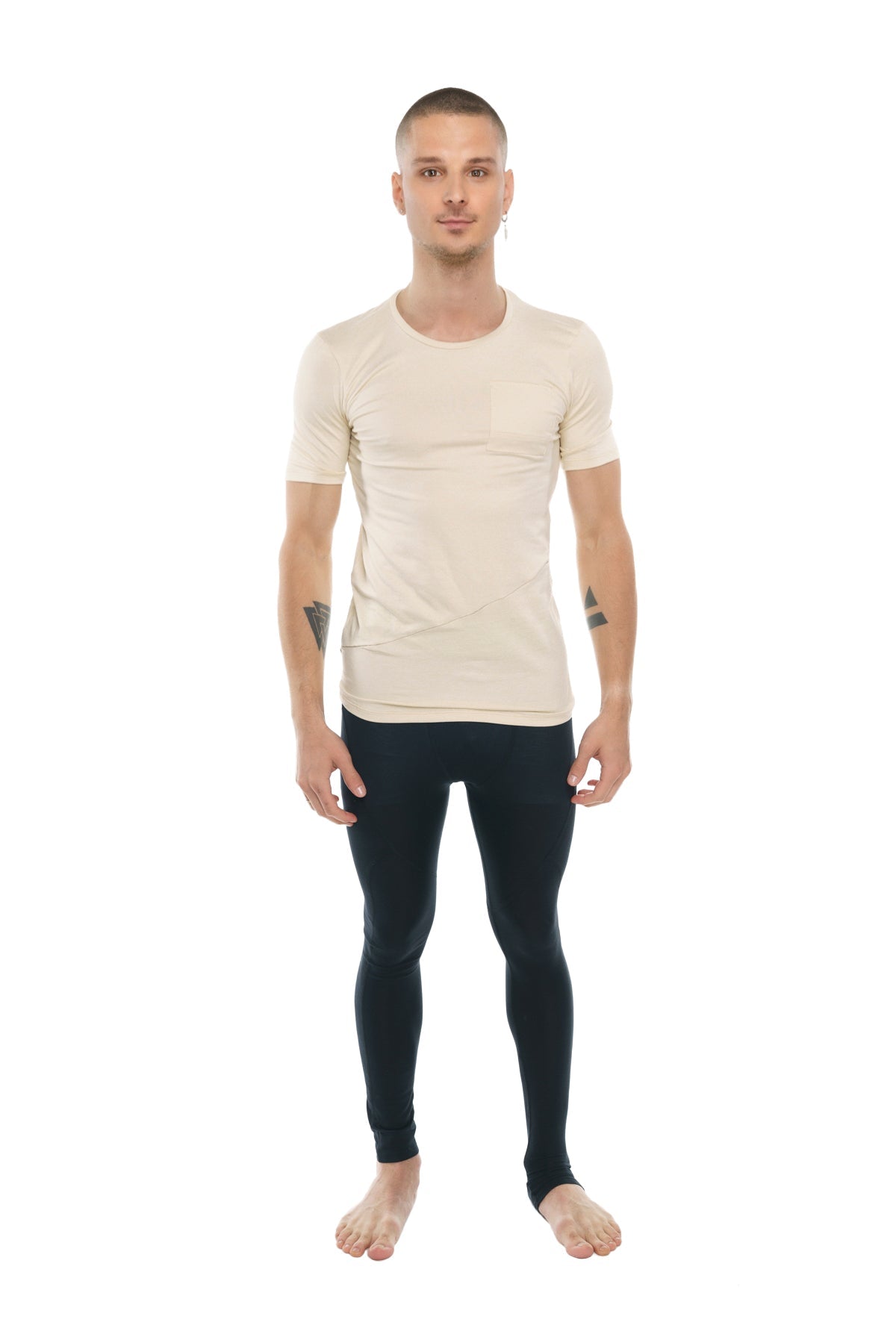 A man wearing a sand beige perfect pocket crew-neck tee paired with black form-fitting leggings shows the front side