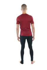 A man wearing a brick red heather perfect pocket crew-neck tee with maroon short sleeves and black leggings