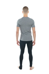 A man wearing a heather gray perfect pocket crew-neck tee in steel heather with black leggings