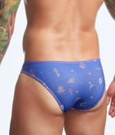 Blue mens swim trunks by justin + simon with playful colorful party-themed icons on a fun print design
