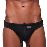 MetroMaleWear classic swim thong black 4902-20 features black drawstring trunks with textured fabric and small red waistband logo