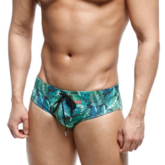 Men’s swim trunks metroMalewear classic swim brief jungle 4914-08 with vibrant teal green tropical leaf pattern and black drawstrings