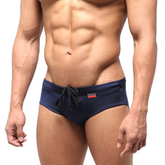 Navy blue metro malewear classic swim brief with black drawstring and red logo on waistband