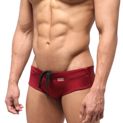 Red swim trunks with black drawstring and small red brand tag from metromalewear classic swim brief wine 4914-42