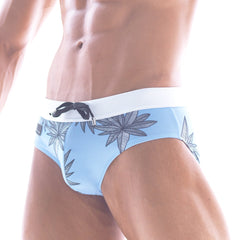 Light blue metroMalewear beach swim brief with white waistband and black leaf pattern for summer swimming