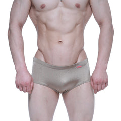 Shiny metallic gold MetroMaleWear Charlie swim briefs with subtle texture and small red brand tag on waistband