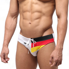White swim trunks by metromalewear with bold black red and yellow german flag stripes for stylish beachwear