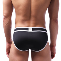 Black MetroMaleWear bold swim briefs with white trim and branded label on waistband for comfortable swimwear use