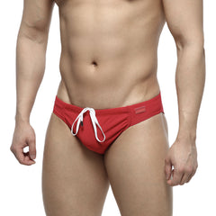Red swim trunks by MetroMaleWear featuring a white drawstring and rectangular brand tag on the waistband