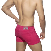 Bright pink 5 pockets summer shorts showing the back side with a gray logo patch on the waistband