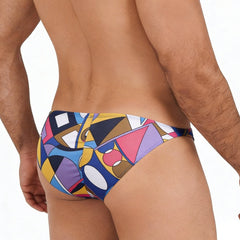 Vibrant geometric-patterned swim trunks in bold blues yellows pinks and purples from metromalewear fantasy bikini picasso 6116-87