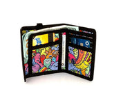 A vibrant black-trimmed 80s velcro tri-fold wallet with colorful cartoon creatures and bold outlines pattern