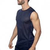 A man wearing a navy mesh sports tank top in a side profile pose against a white background.