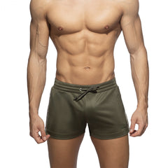 Nexus button shorts olive green athletic shorts with white side stripes and drawstring waistband for activewear