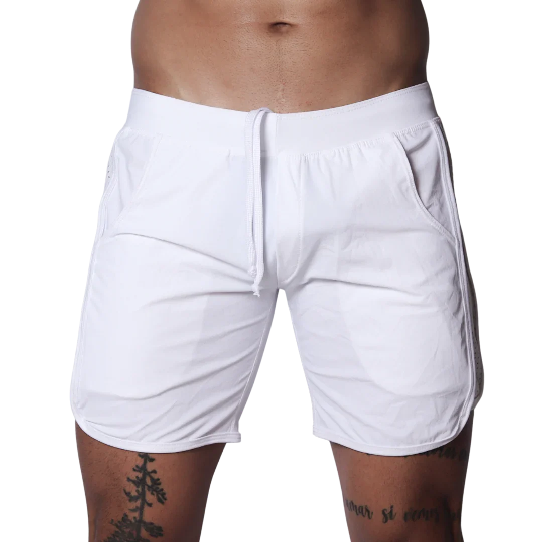 White athletic shorts featuring an elastic waistband with drawstring, side pockets, and curved hem detail.