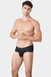A man models AWRY Menswear Lift Briefs in black against a plain background.