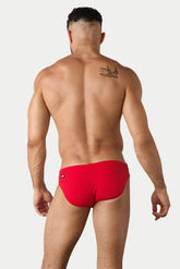 AWRY Menswear Oaisis Classic Swim Brief in red worn by a male model, rear view.