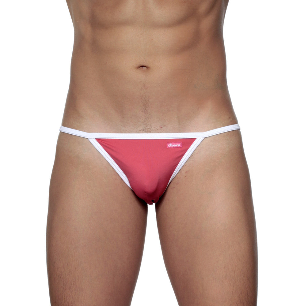A vibrant pink groovin accent string bikini rouge red thong with white trim and a small brand tag front view