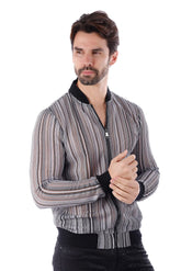 A man wearing a funky novelty bomber jacket with black and white stripes and ribbed cuffs and collar