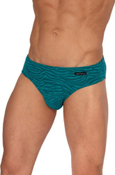 A model wears emerald green Olaf Benz beach brief swimwear with a tonal wave pattern.