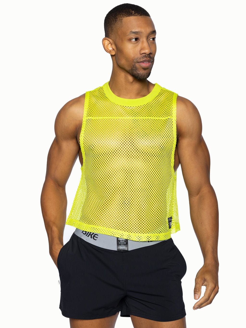 A bright neon yellow BIKE sleeve-less practice jersey mesh tank top with round neckline and subtle perforations