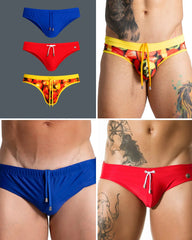 Trio of men's swim briefs in blue, red, and tropical print, featuring elastic waistbands and drawstring cords.