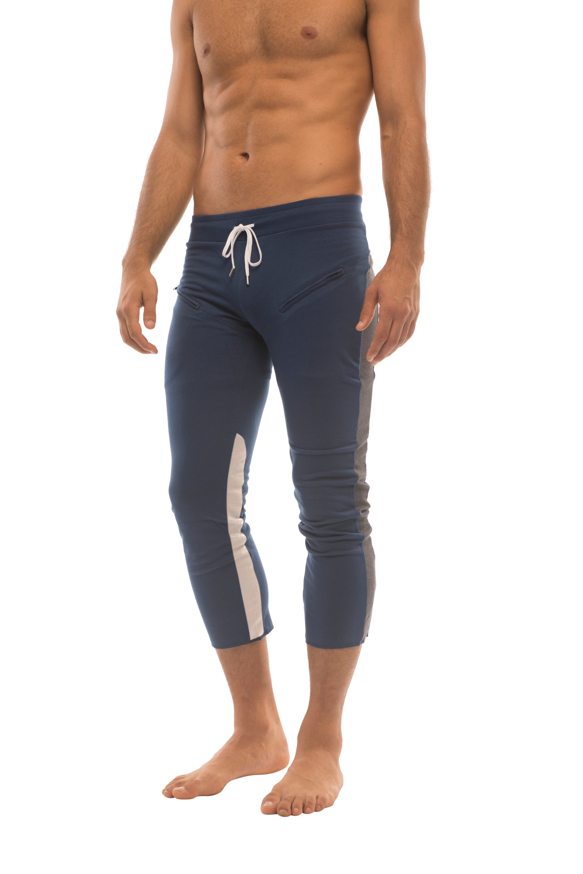Mens navy blue athletic capri yoga pants with white side stripes and matching drawstring waistband