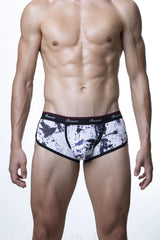 Black and white splatter-patterned men’s briefs with red-trimmed waistband featuring sroovin brand name groovin underwear
