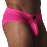 Fuchsia brief in textured, honeycomb-patterned fabric featuring a contoured pouch and a small black rectangular logo.