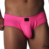 Fuchsia-colored low-rise briefs in textured mesh fabric with a centered black logo patch on the waistband.