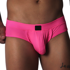 Fuchsia-colored low-rise briefs in textured mesh fabric with a centered black logo patch on the waistband.
