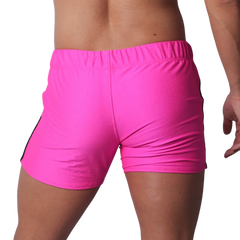 Fuchsia athletic short-shorts in a textured performance fabric with an elastic waistband, viewed from the back.