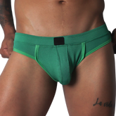 Green jockstrap featuring a textured honeycomb fabric, wide waistband, and a solid black central logo patch.