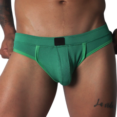 Green jockstrap featuring a textured honeycomb fabric, wide waistband, and a solid black central logo patch.