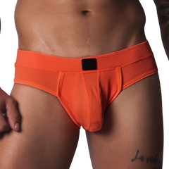Bright orange athletic jockstrap made of textured honeycomb fabric with a solid black center label on the waistband.