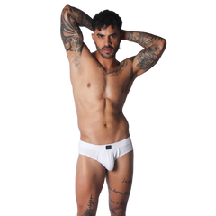 White low-rise cotton brief with a textured knit fabric, contoured pouch, and small black rectangular center logo.