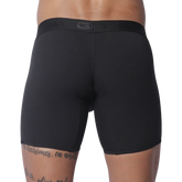 Solid black fitted boxer trunks with a wide, tonal branded elastic waistband.