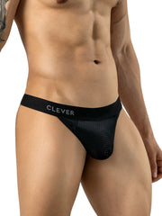 Man wearing black mesh thong with a branded elastic waistband on a white background.
