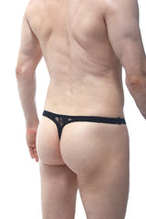Black lace thong from PetitQ with a solid band and delicate floral pattern shown from the back side
