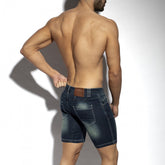Rear view of a shirtless man modeling ES Collection dark denim Bermuda jean shorts against a white background.