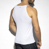 Rear view of a man wearing a white ES Collection Recycle Rib Tank Top with a small logo on the back.